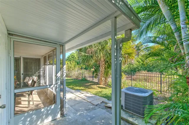 a view of a porch with furniture and garden