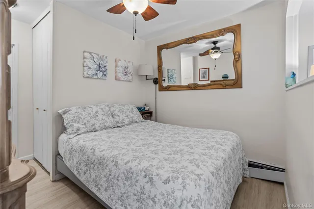 a bedroom with a bed and painting on the wall