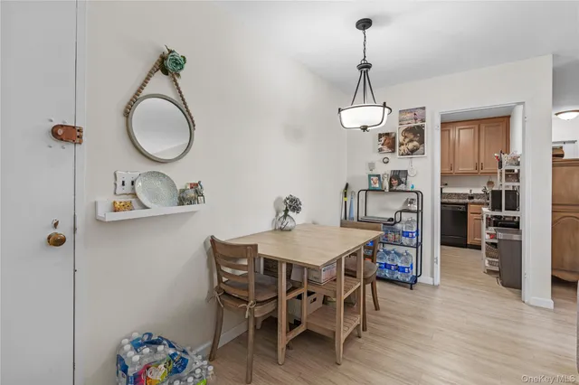 a dining room with furniture a chandelier and wooden floor