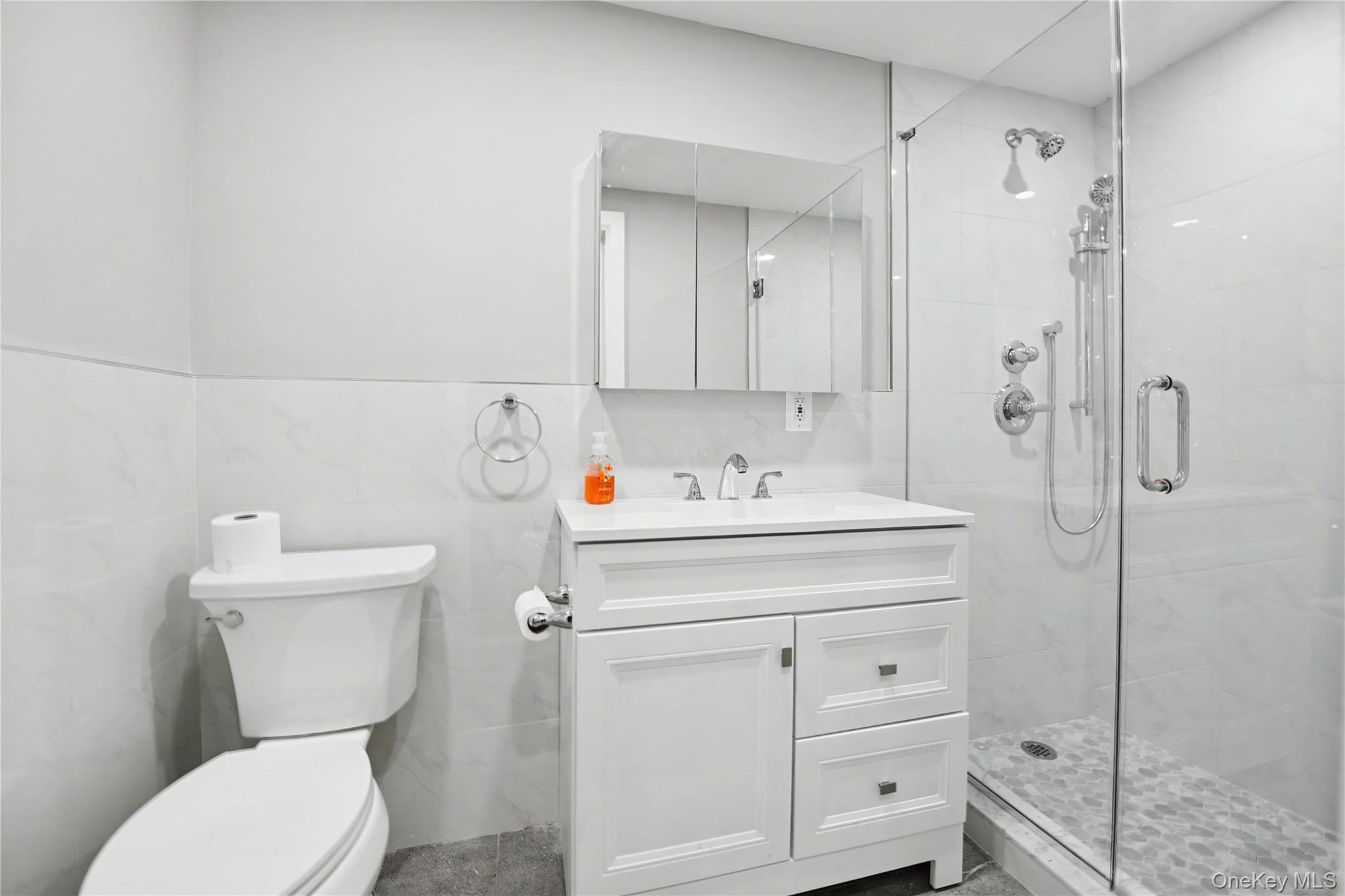 79-47 68th Road Queens, NY 11379 - Photo 12 of 29 a bathroom with a sink a toilet and shower