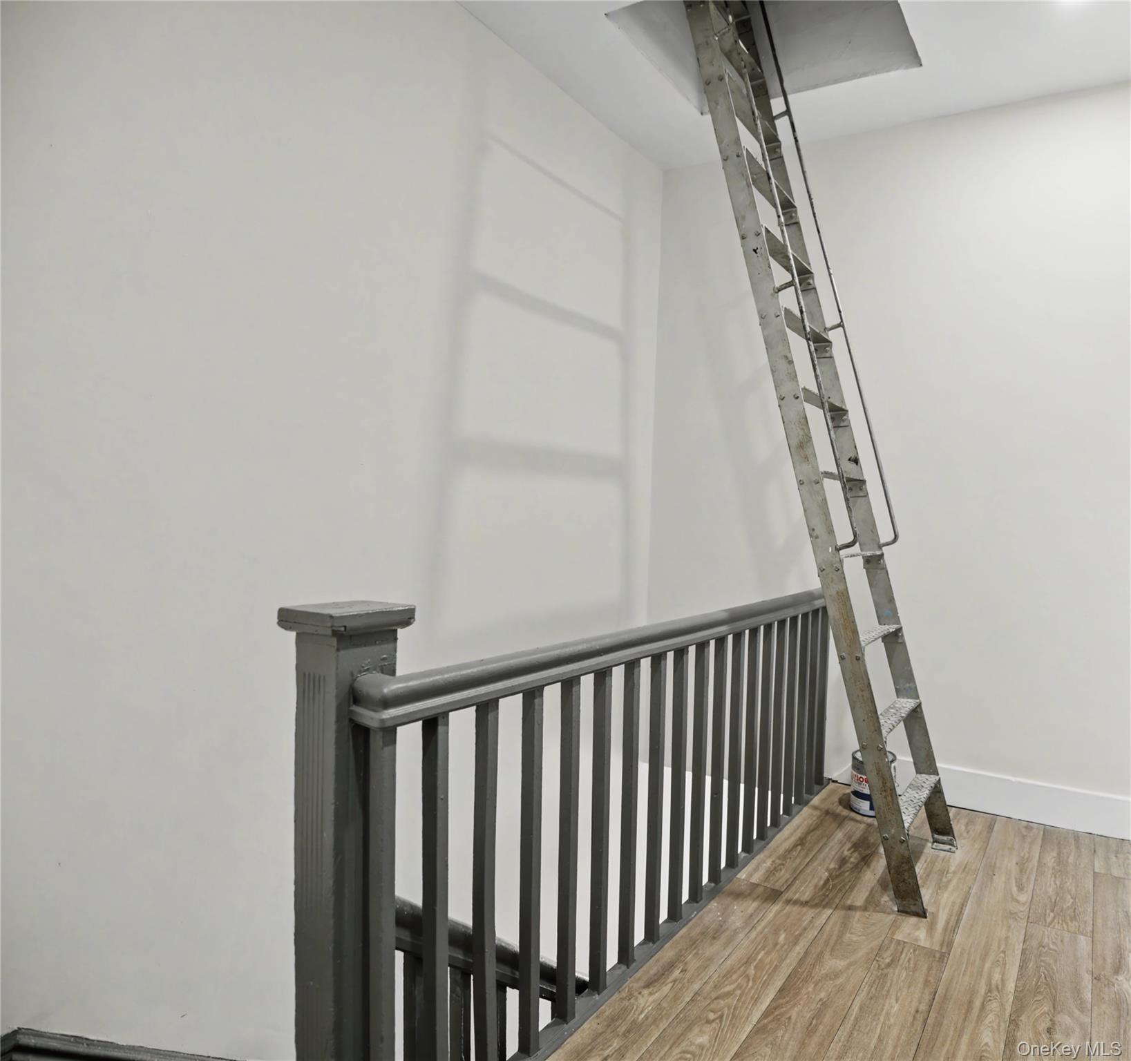 79-47 68th Road Queens, NY 11379 - Photo 13 of 29 a view of staircase with white walls and a window