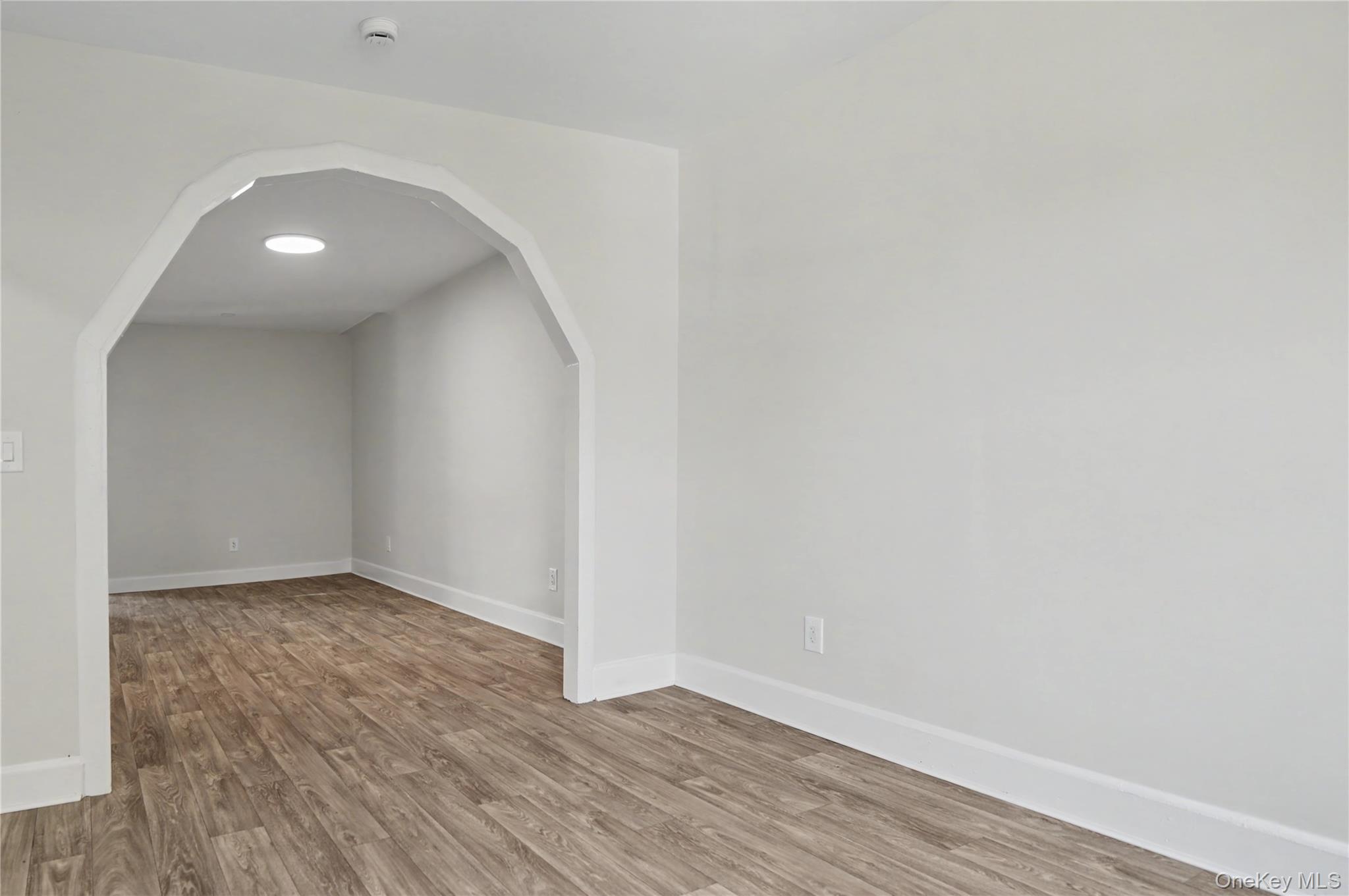 79-47 68th Road Queens, NY 11379 - Photo 18 of 29 a view of an empty room with wooden floor