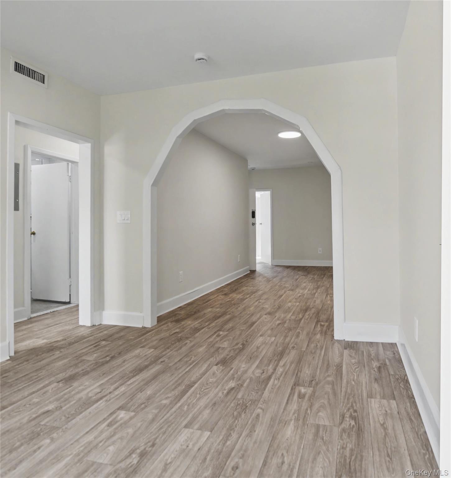 79-47 68th Road Queens, NY 11379 - Photo 19 of 29 wooden floor in an empty room with wooden floor