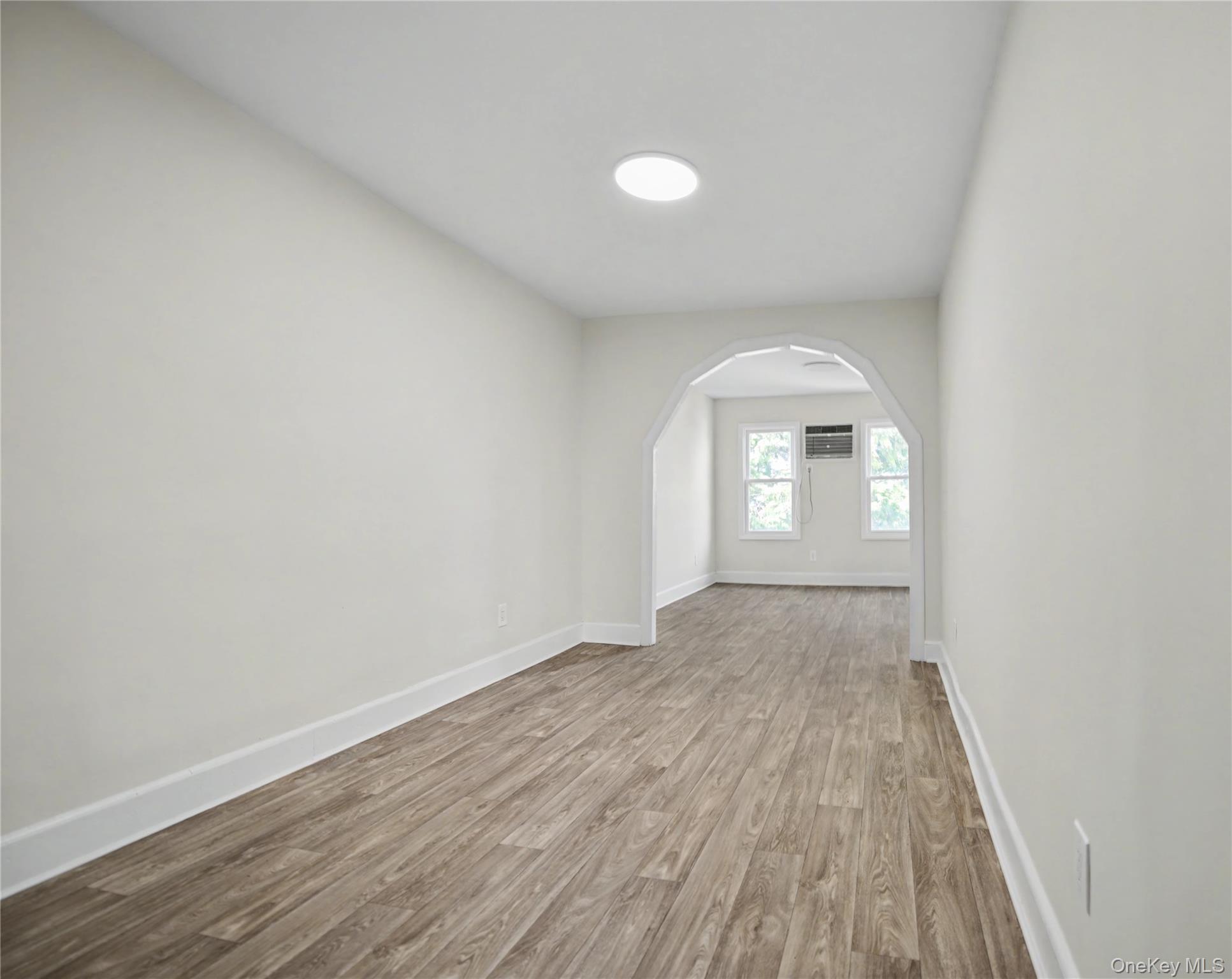 79-47 68th Road Queens, NY 11379 - Photo 20 of 29 an empty room with wooden floor and windows