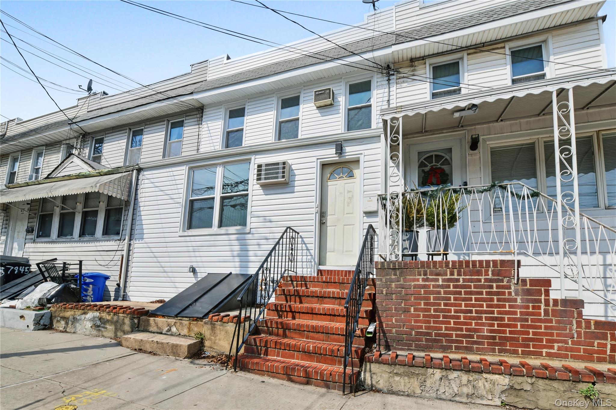 79-47 68th Road Queens, NY 11379 - Photo 2 of 29 a front view of a house with a street