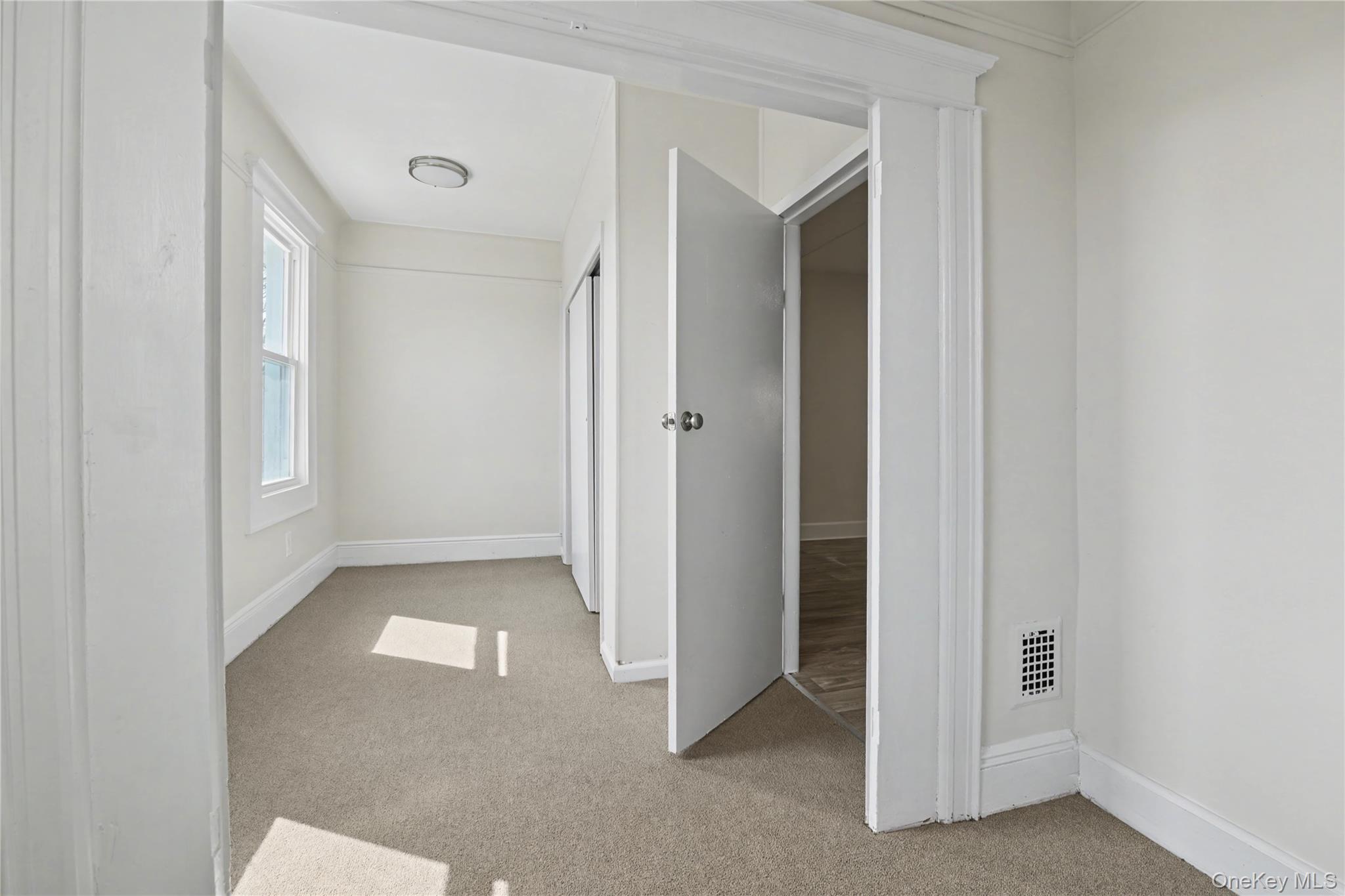 79-47 68th Road Queens, NY 11379 - Photo 21 of 29 a view of an empty room and window