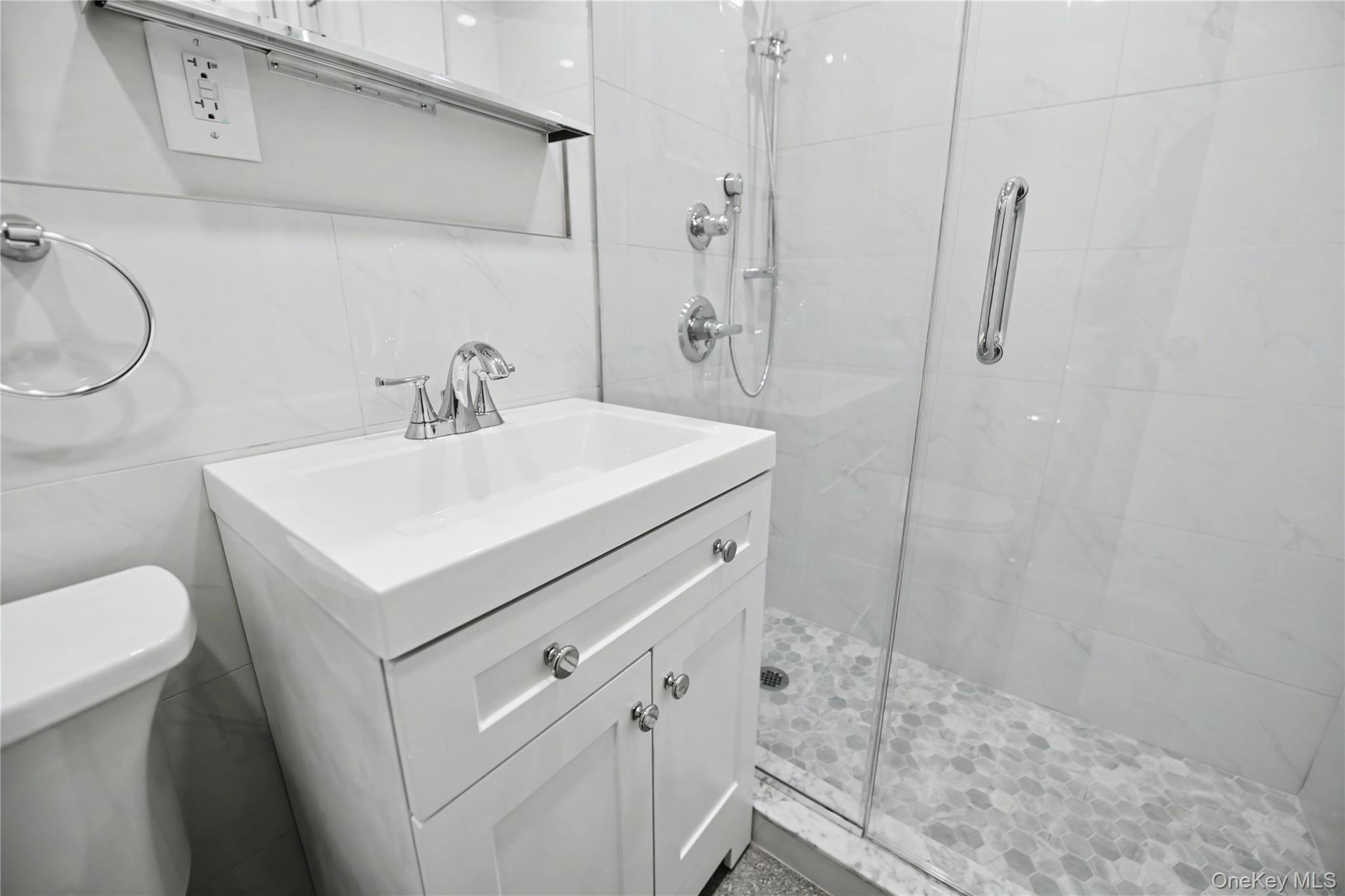79-47 68th Road Queens, NY 11379 - Photo 23 of 29 a bathroom with a sink a toilet and shower