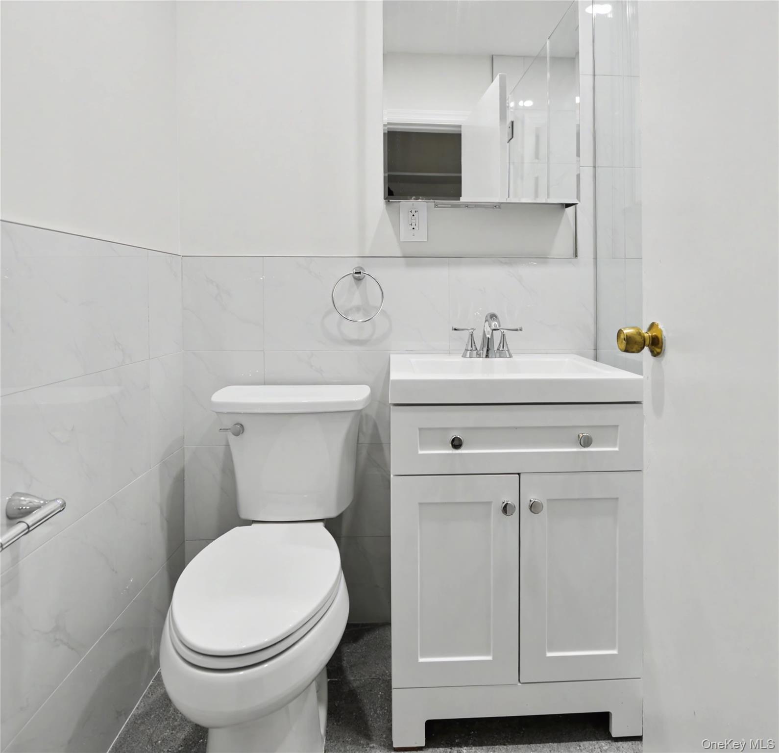 79-47 68th Road Queens, NY 11379 - Photo 24 of 29 a bathroom with a toilet a sink and a mirror