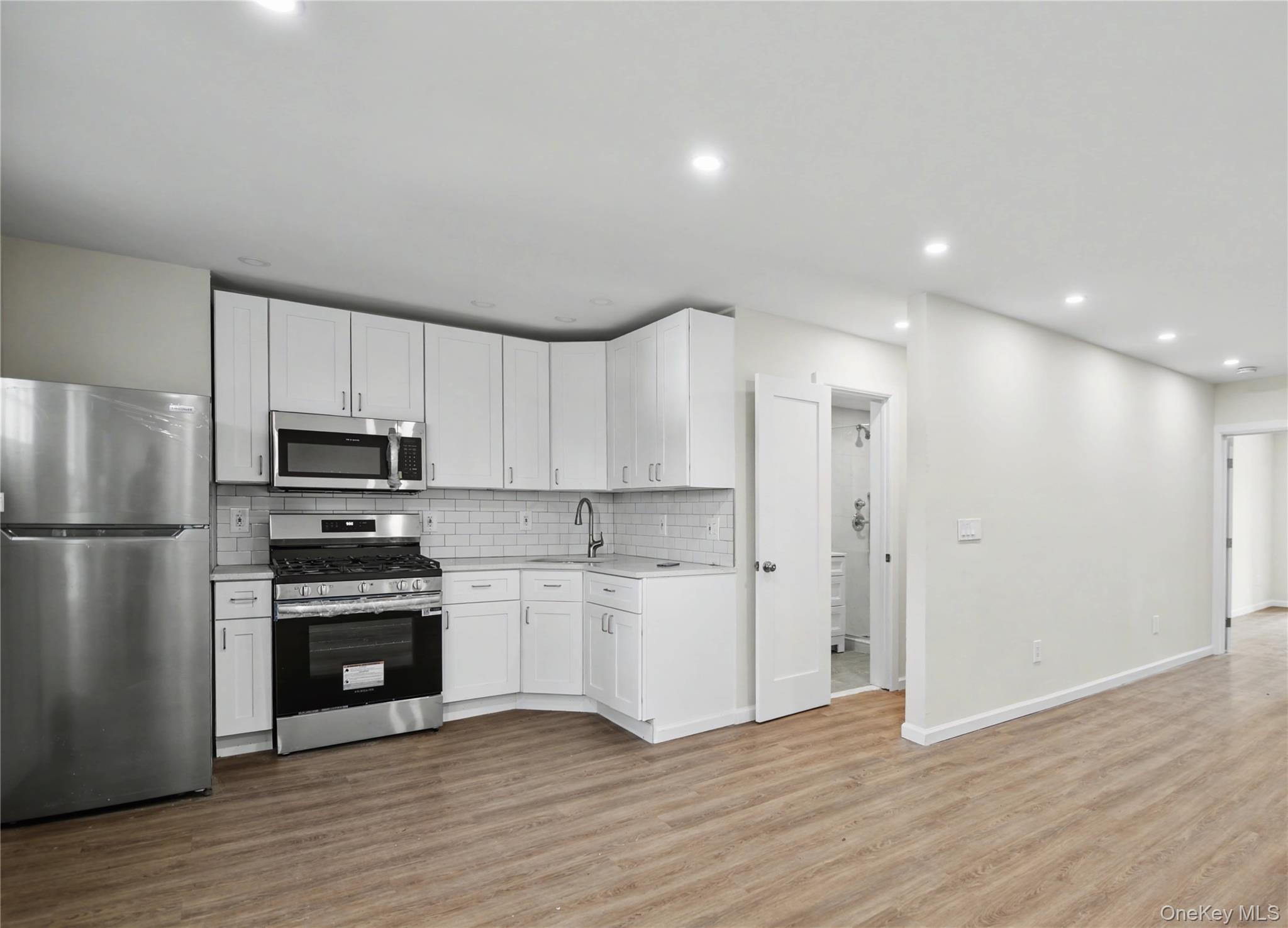 79-47 68th Road Queens, NY 11379 - Photo 4 of 29 a kitchen with a refrigerator and a stove top oven
