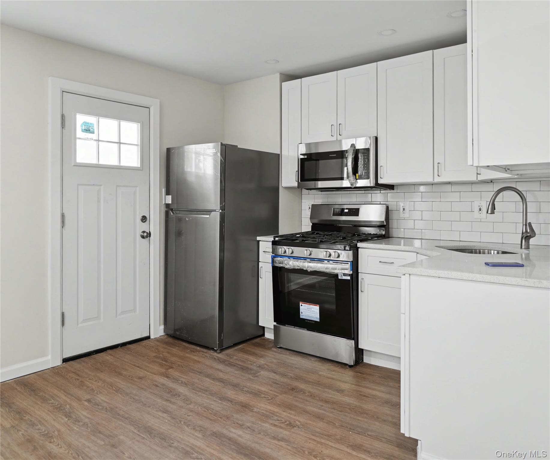 79-47 68th Road Queens, NY 11379 - Photo 6 of 29 a kitchen with stainless steel appliances granite countertop a refrigerator sink and stove