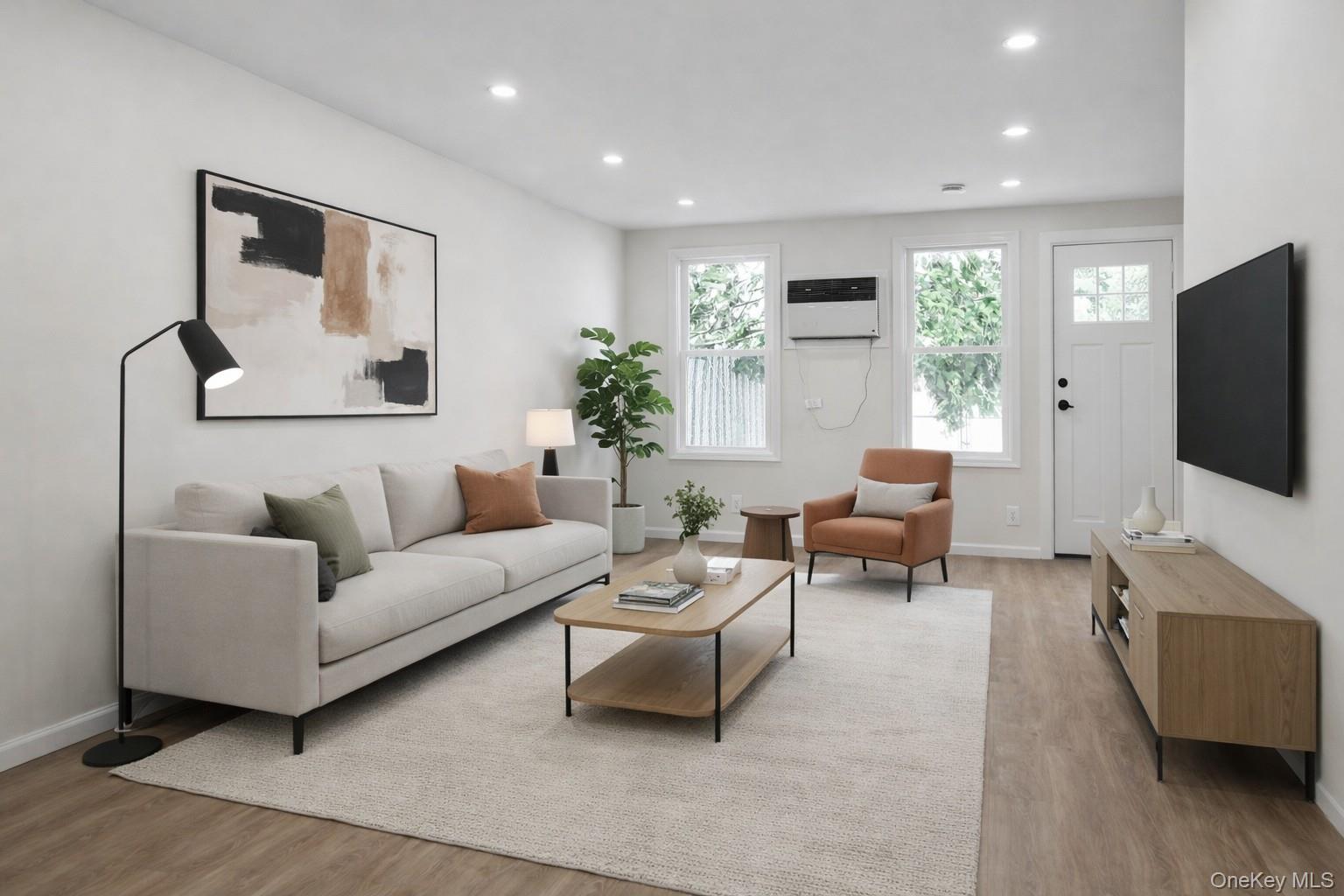 79-47 68th Road Queens, NY 11379 - Photo 7 of 29 a living room with furniture a flat screen tv and a large window