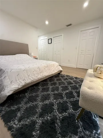 a bedroom with a bed and a couch