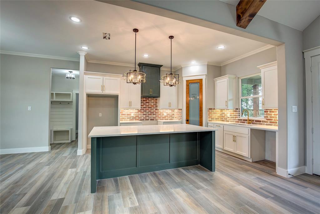 405 Door Key Ranch Road Trinidad, TX 75163 - Photo 8 of 28 Kitchen with white cabinetry, a center island, and light wood-type flooring