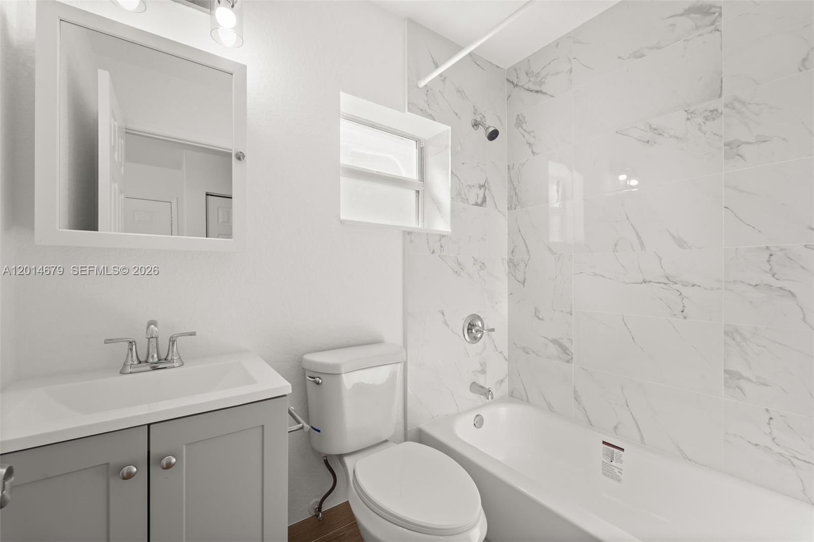 255 Beacom Boulevard, Unit DOWNSTAIRS Miami, FL 33135 - Photo 11 of 36 a bathroom with a sink toilet and shower