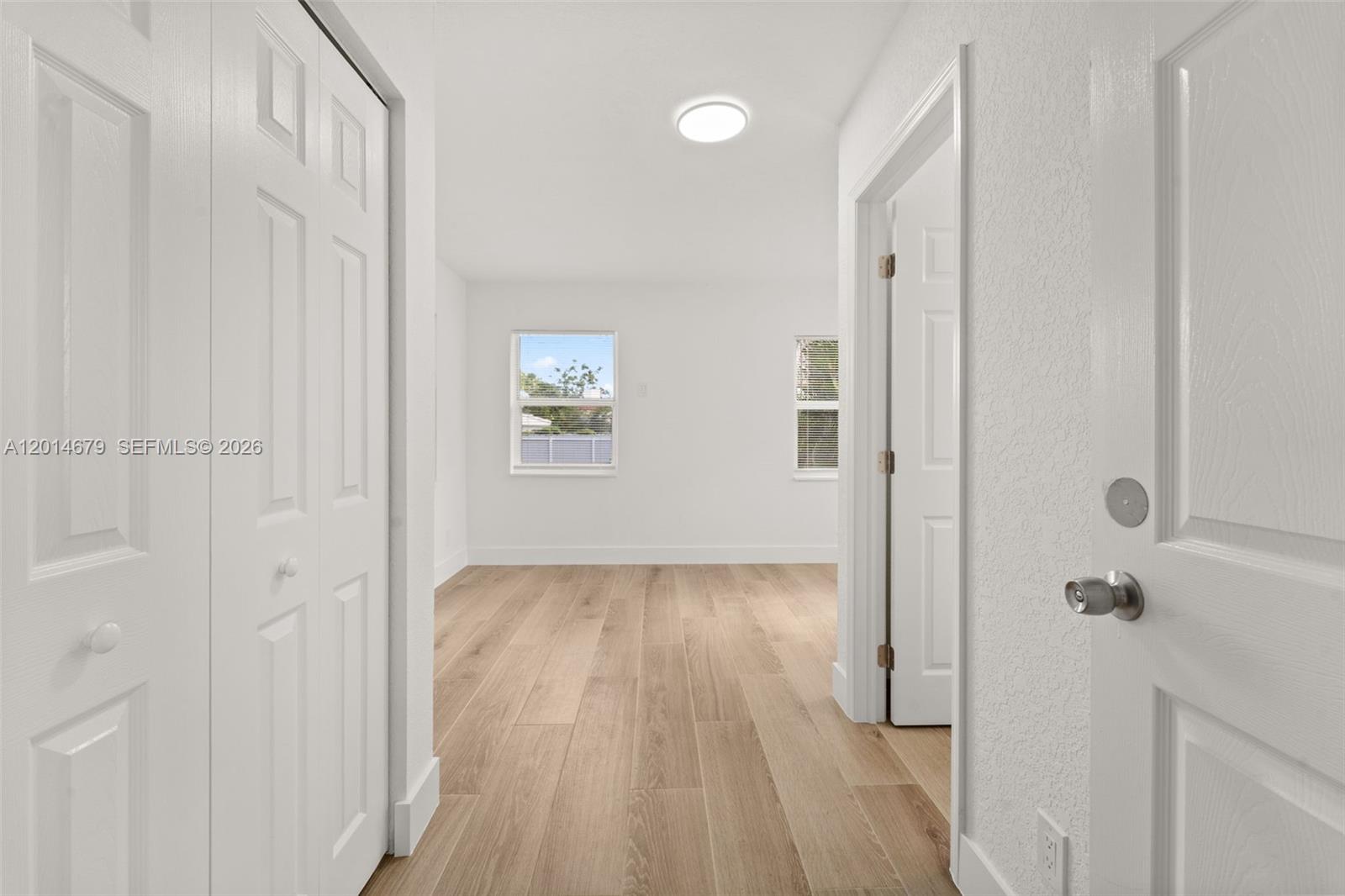 255 Beacom Boulevard, Unit DOWNSTAIRS Miami, FL 33135 - Photo 12 of 36 a view of a hallway with wooden floor and a bathroom