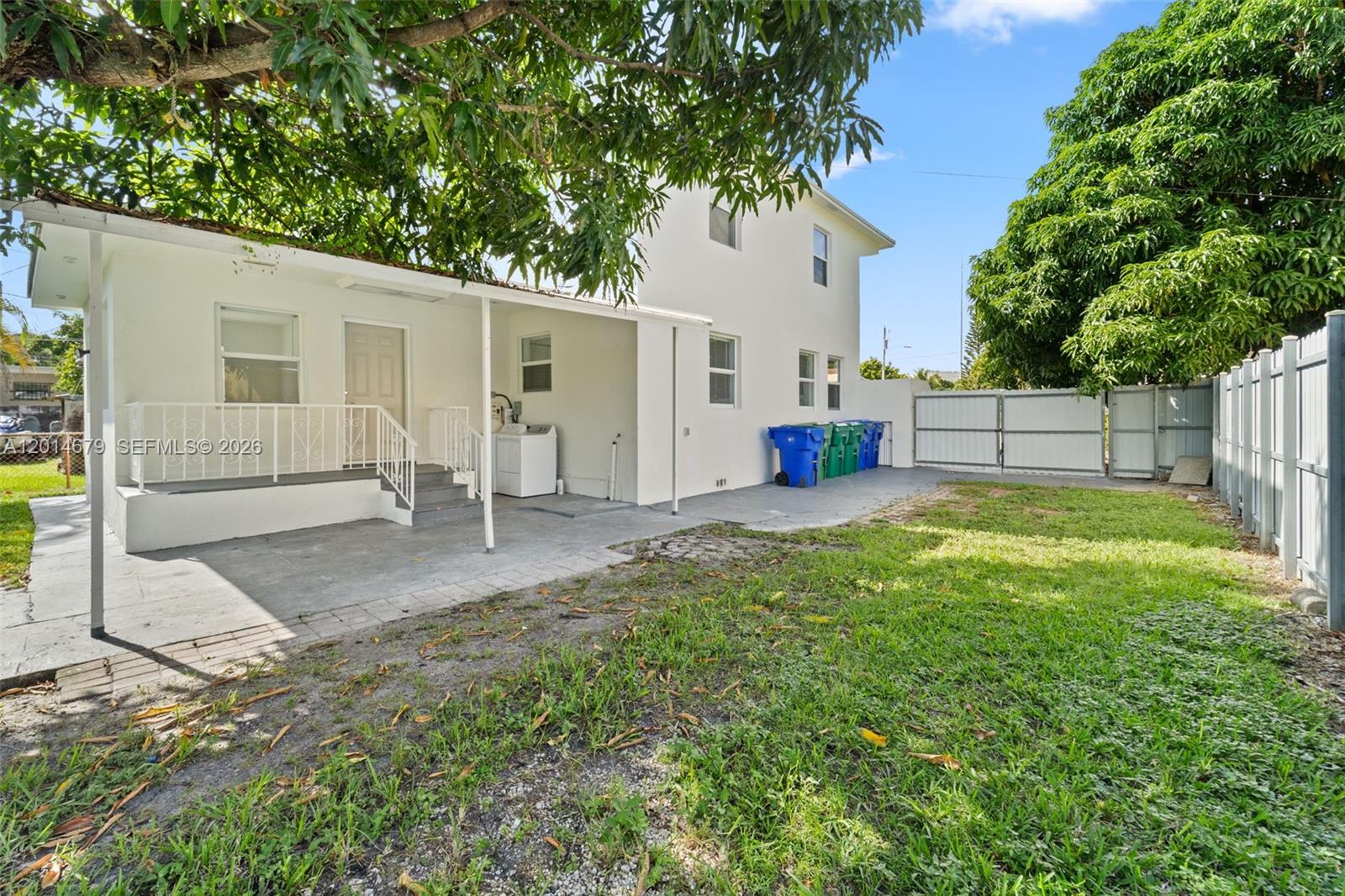 255 Beacom Boulevard, Unit DOWNSTAIRS Miami, FL 33135 - Photo 15 of 36 a view of a house with backyard and a tree