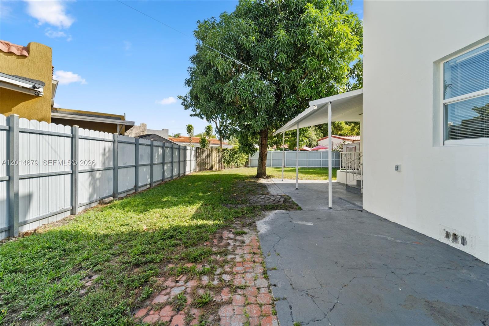255 Beacom Boulevard, Unit DOWNSTAIRS Miami, FL 33135 - Photo 17 of 36 a view of a house with backyard and sitting area