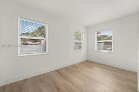 a view of room with window and hardwood floor