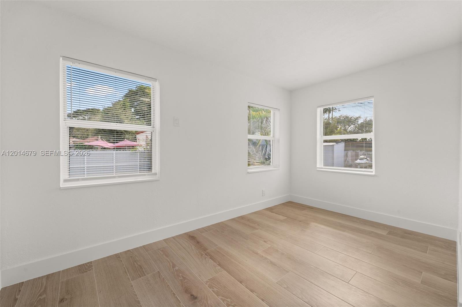 255 Beacom Boulevard, Unit DOWNSTAIRS Miami, FL 33135 - Photo 31 of 36 a view of room with window and hardwood floor