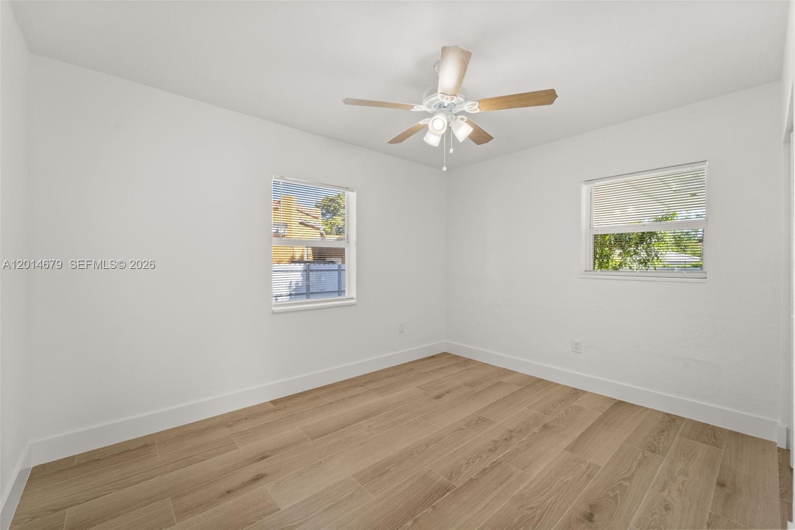 255 Beacom Boulevard, Unit DOWNSTAIRS Miami, FL 33135 - Photo 8 of 36 a view of empty room with wooden floor