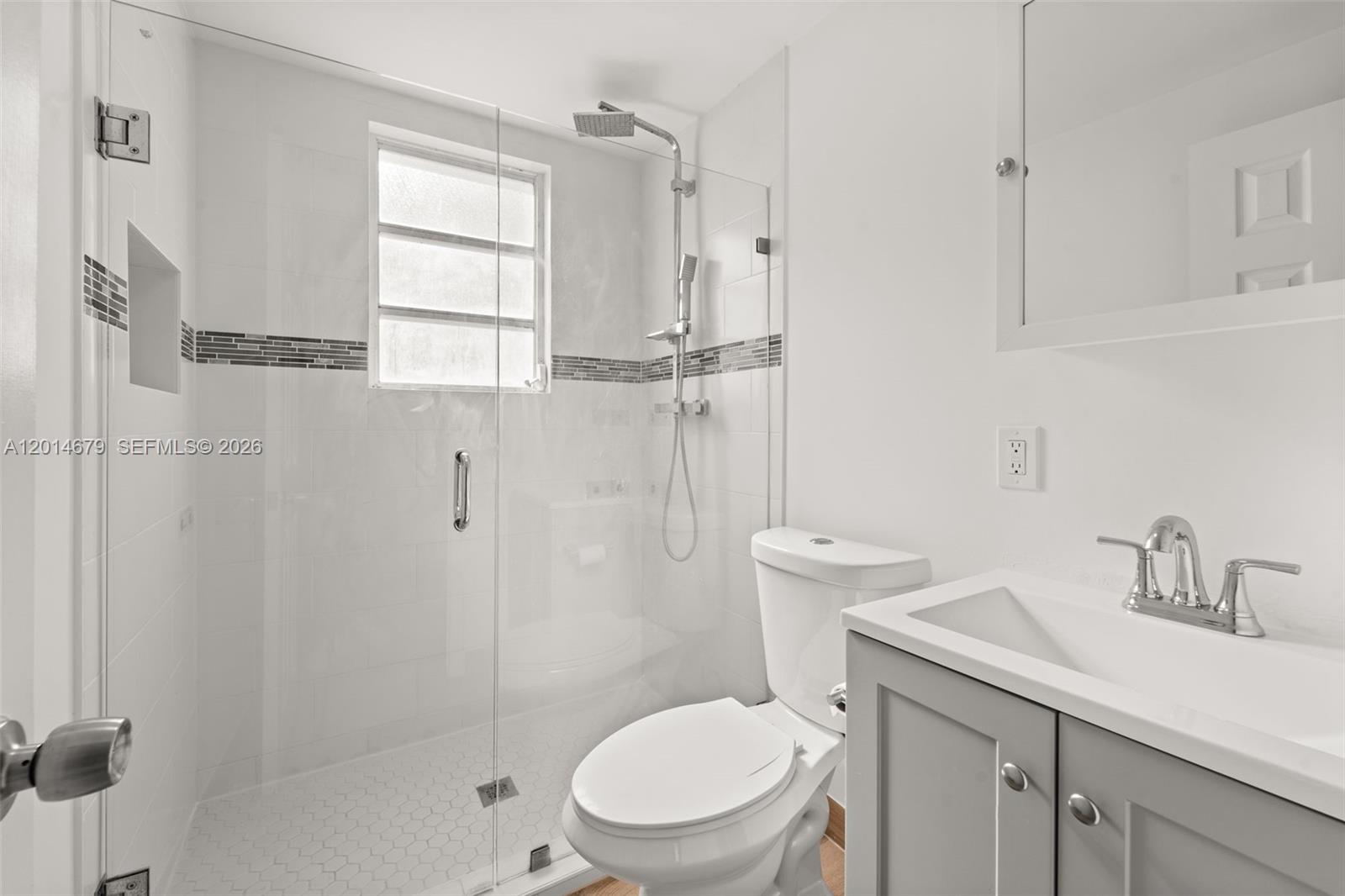 255 Beacom Boulevard, Unit DOWNSTAIRS Miami, FL 33135 - Photo 9 of 36 a bathroom with a toilet sink vanity and shower