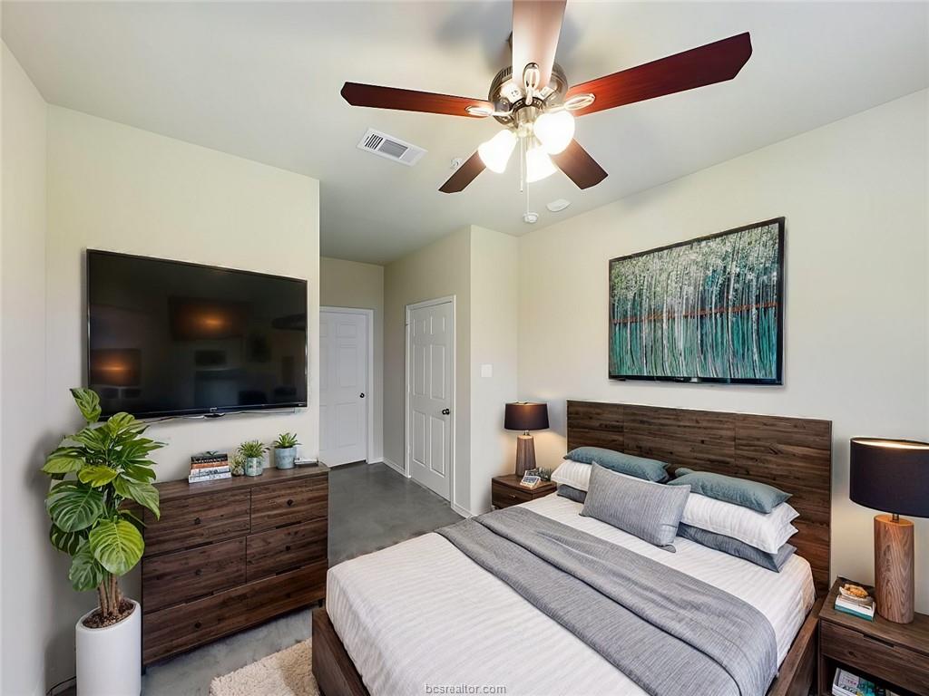 2910 Town Square Avenue, Unit 2101 Bryan, TX 77802 - Photo 5 of 7 Bedroom featuring concrete flooring and a ceiling fan