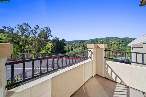 a view of a balcony with wooden fence and floor