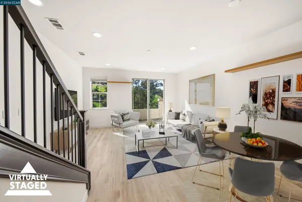 a living room with lots of furniture and a large window