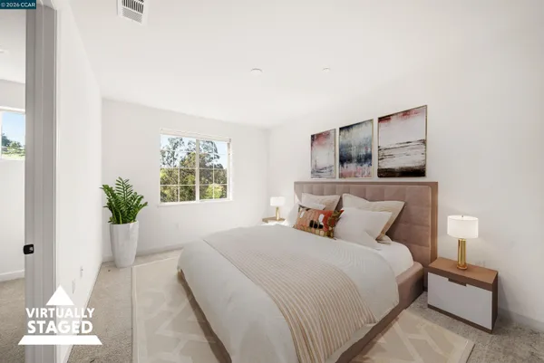 a bedroom with a bed and a potted plant
