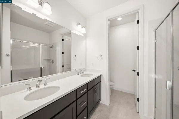a bathroom with double vanity sinks and a mirror