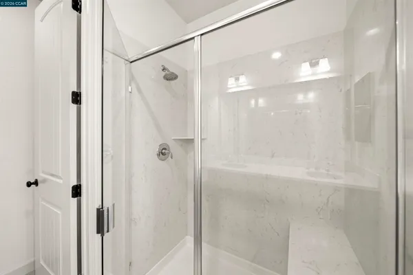 a bathroom with a glass shower door