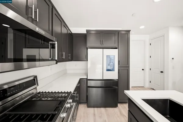 a kitchen with a sink and stainless steel appliances
