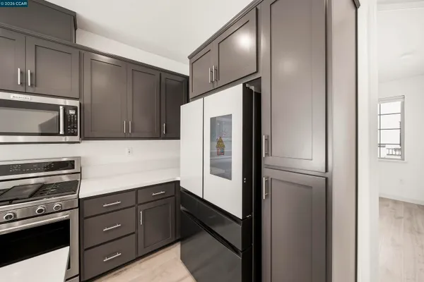 a kitchen with stainless steel appliances a refrigerator and cabinets