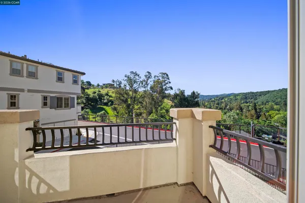 a view of a balcony with wooden fence and floor