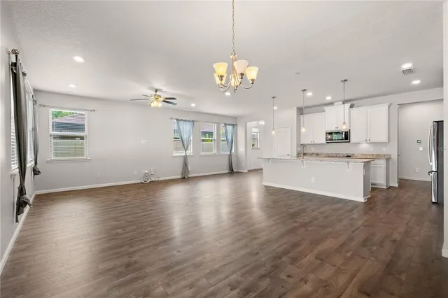 a view of a kitchen with a dishwasher cabinets and wooden floor