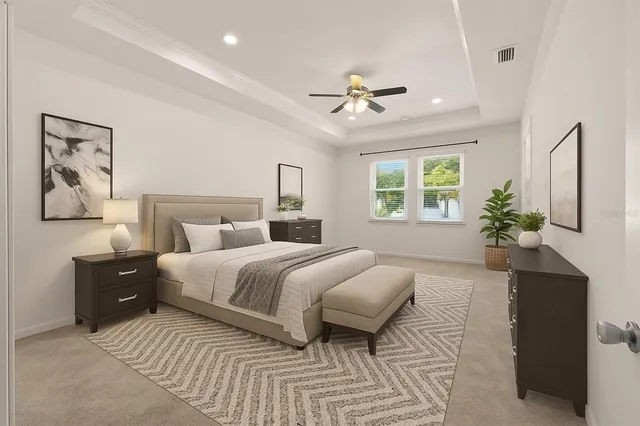 a bedroom with a large bed and a chandelier