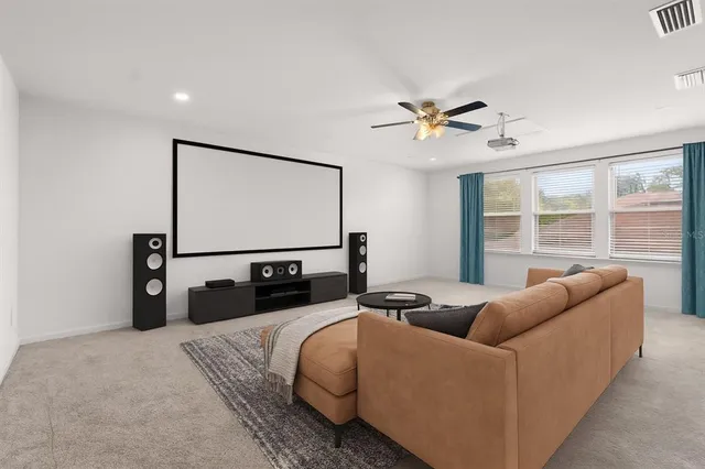 a living room with furniture a chandelier and a flat screen tv
