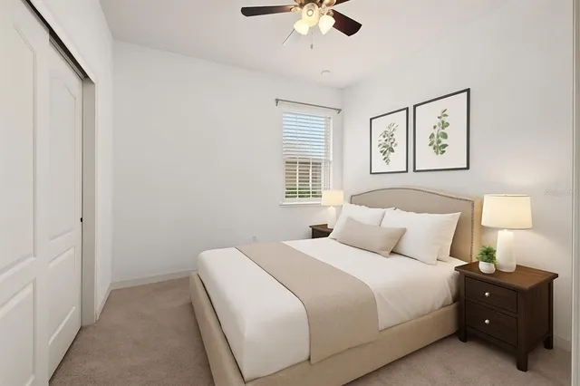 a bedroom with a bed and painting on the wall