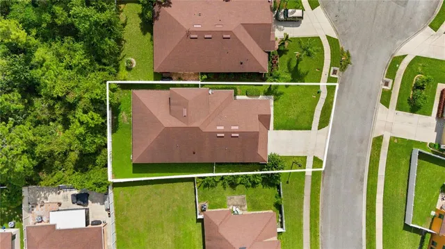 an aerial view of a house with a swimming pool