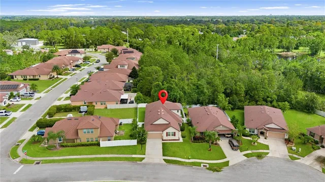 an aerial view of multiple houses with a yard