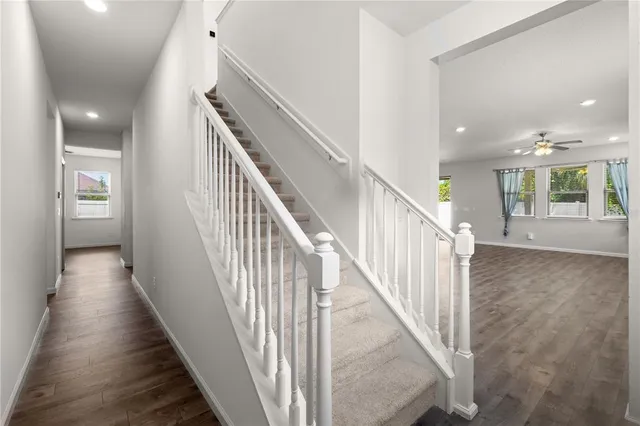 a view of a hallway with wooden floor and entryway