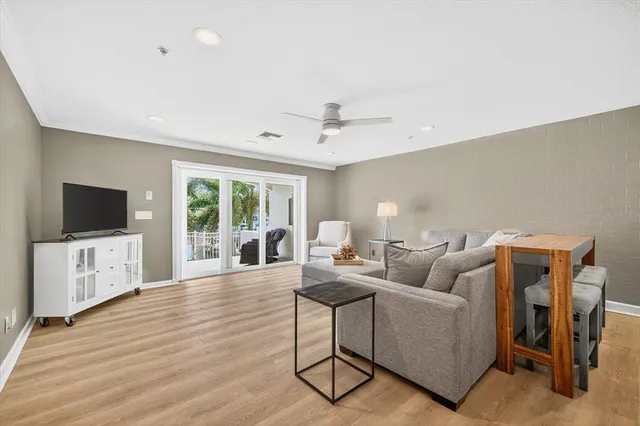 a spacious bedroom with a large bed and a chandelier