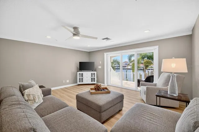 a spacious bedroom with a bed and a flat screen tv