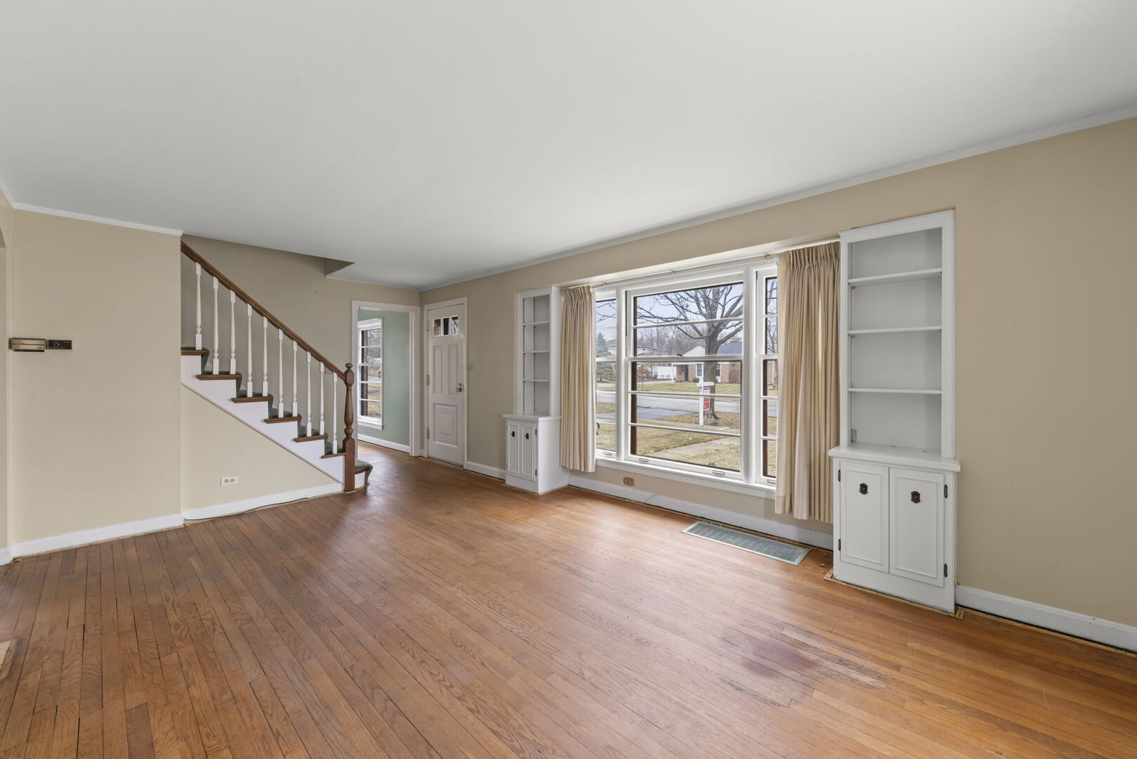 1818 East Indiana Street Wheaton, IL 60187 - Photo 3 of 29 a view of an empty room with wooden floor and a window