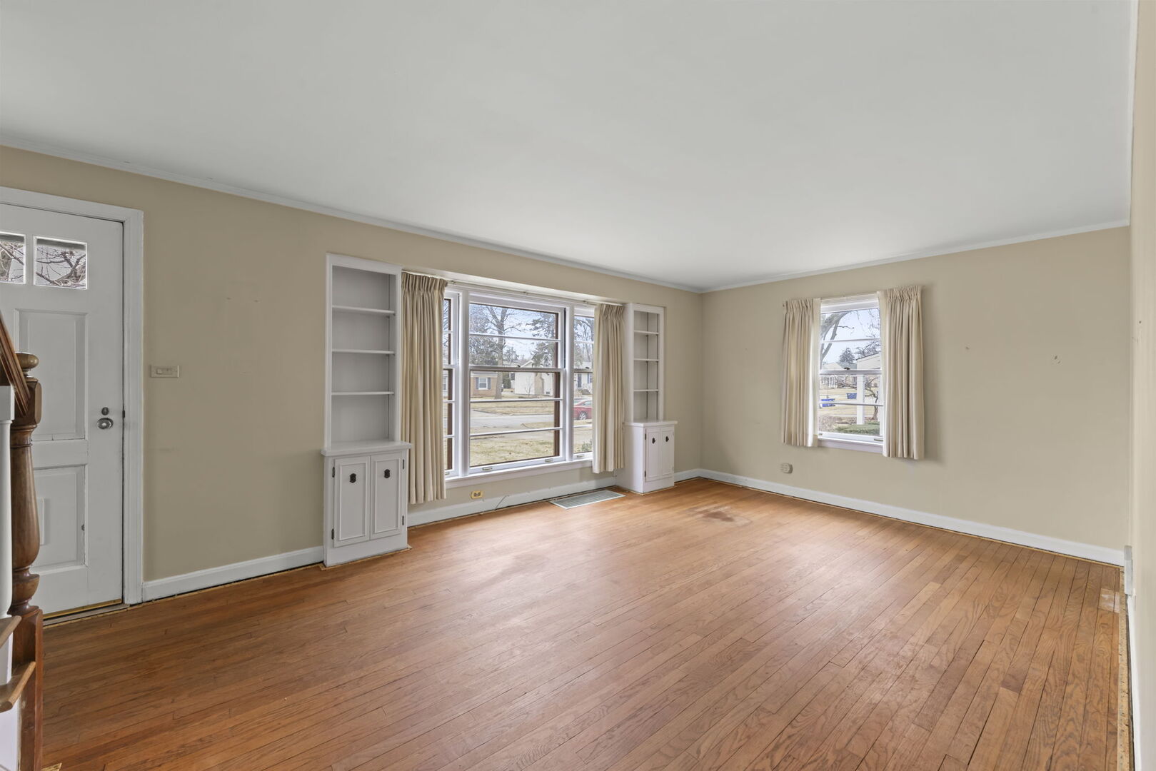 1818 East Indiana Street Wheaton, IL 60187 - Photo 4 of 29 an empty room with wooden floor and windows