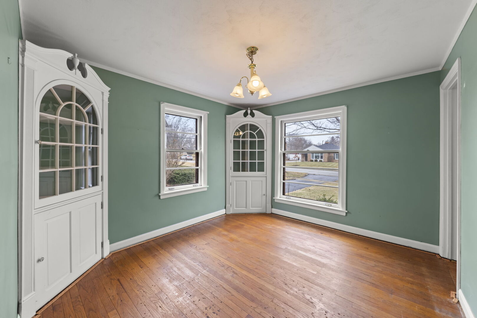 1818 East Indiana Street Wheaton, IL 60187 - Photo 5 of 29 an empty room with wooden floor cabinet and windows