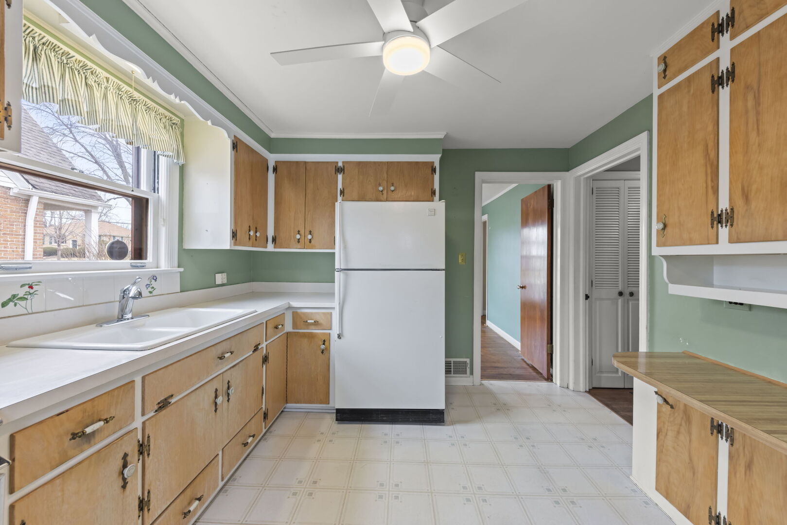 1818 East Indiana Street Wheaton, IL 60187 - Photo 9 of 29 a kitchen with a refrigerator and a sink