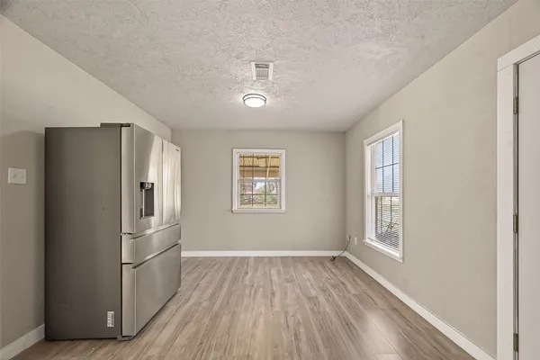 a kitchen with stainless steel appliances a refrigerator and a window
