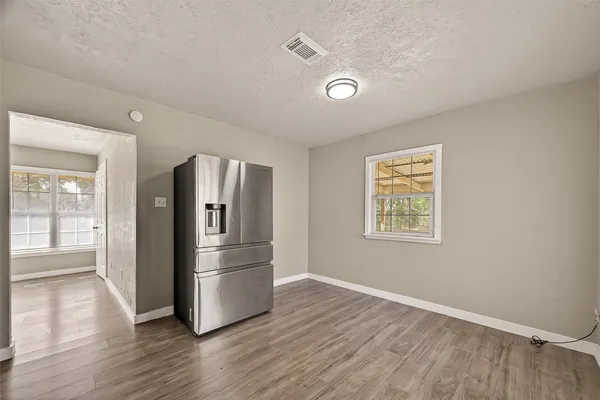 a kitchen with stainless steel appliances granite countertop a refrigerator and a stove top oven