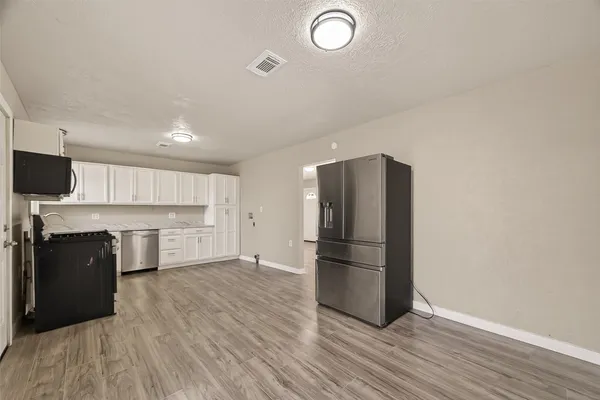 a kitchen with a refrigerator and a stove